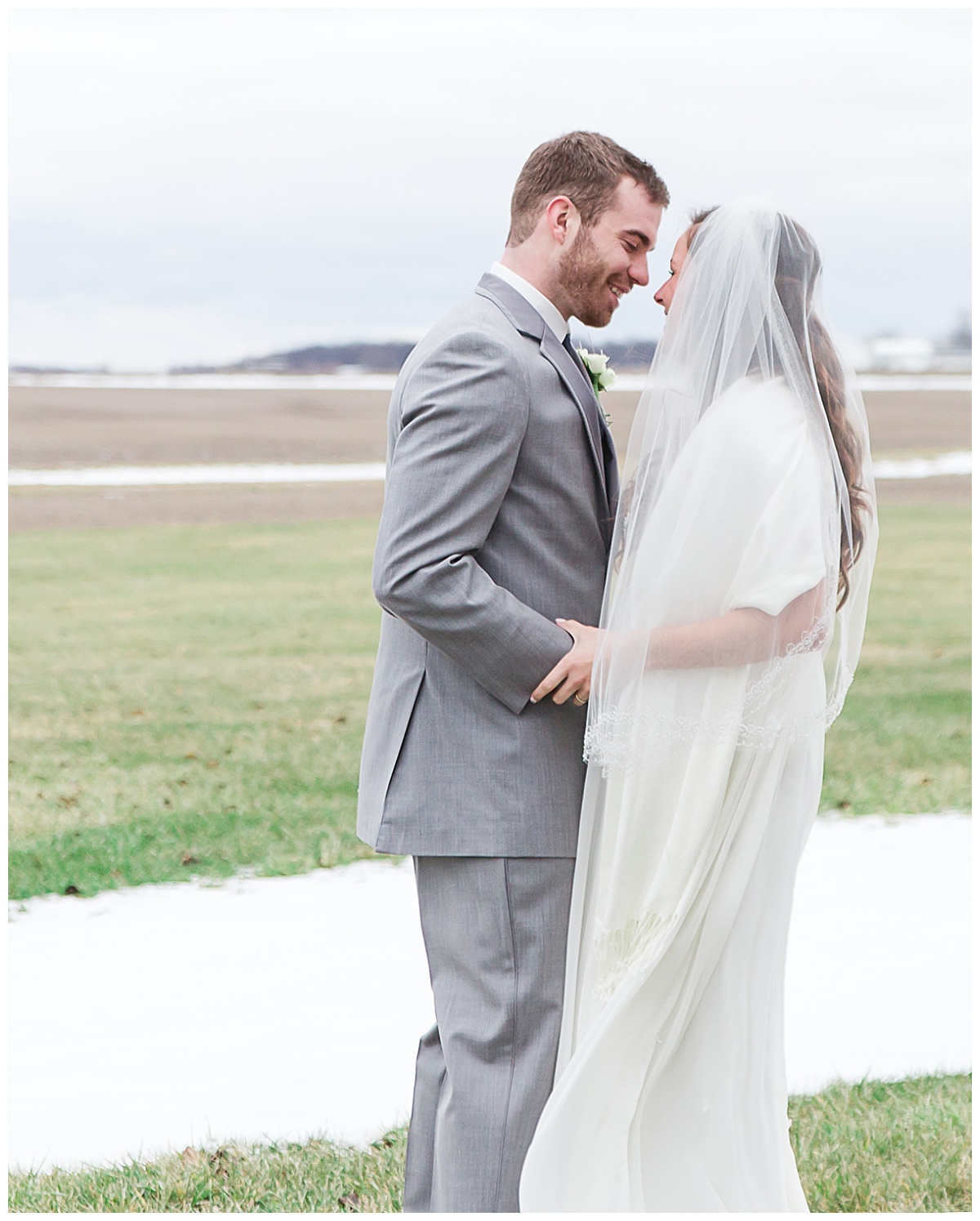 bride and groom sharing first look, in winter grassy area