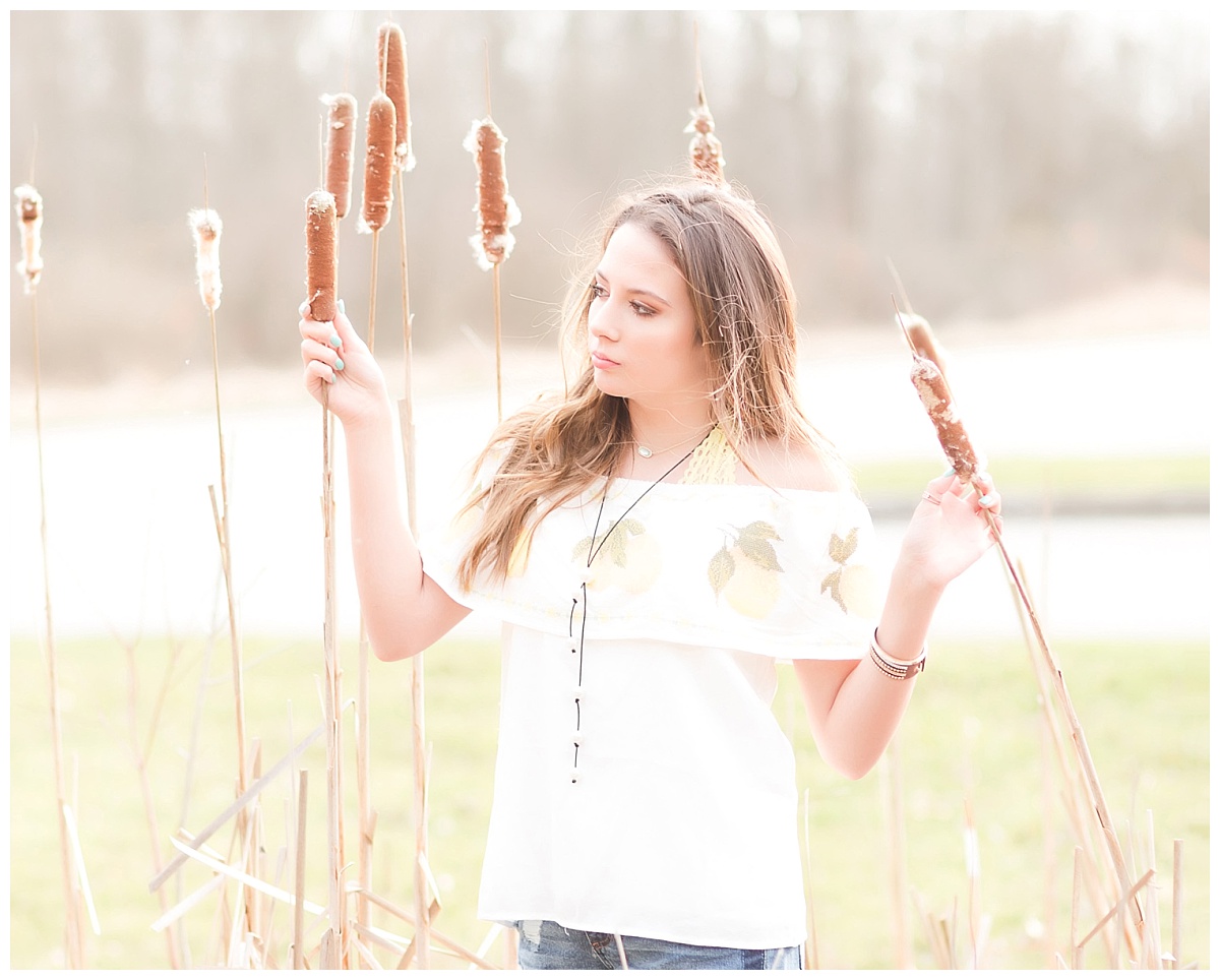senior girl- standing among cattails