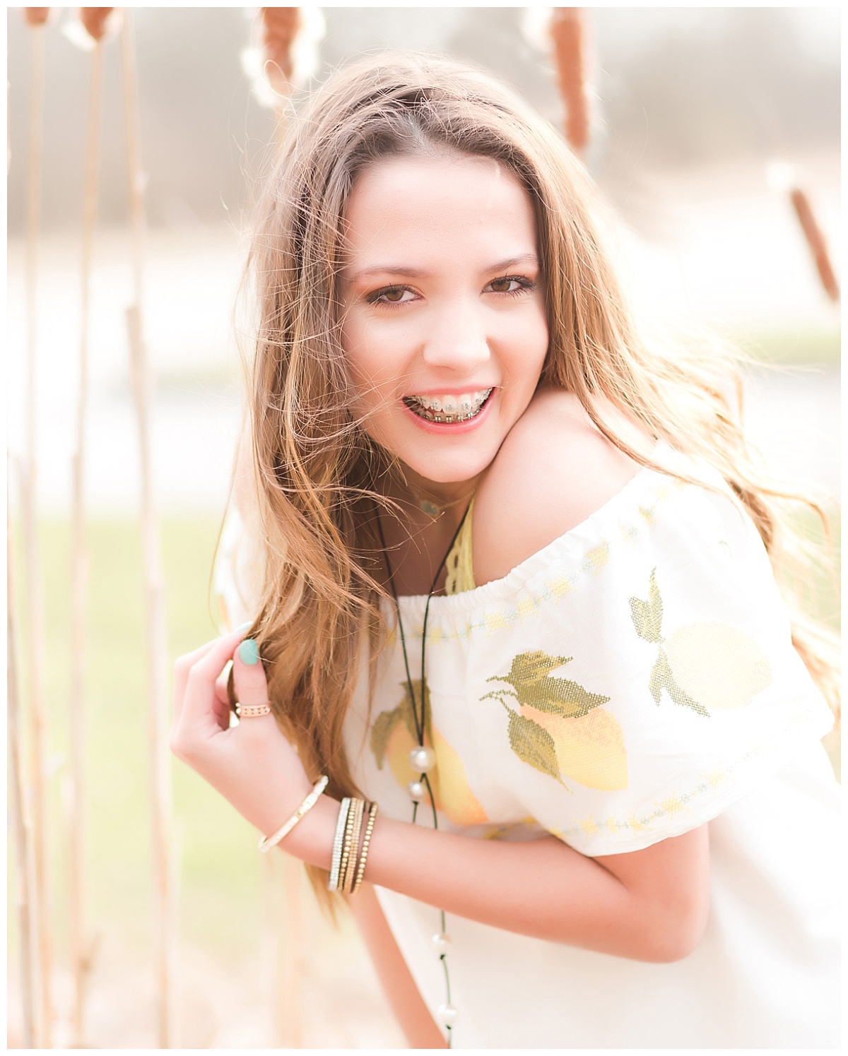 senior girl smiling in nature setting