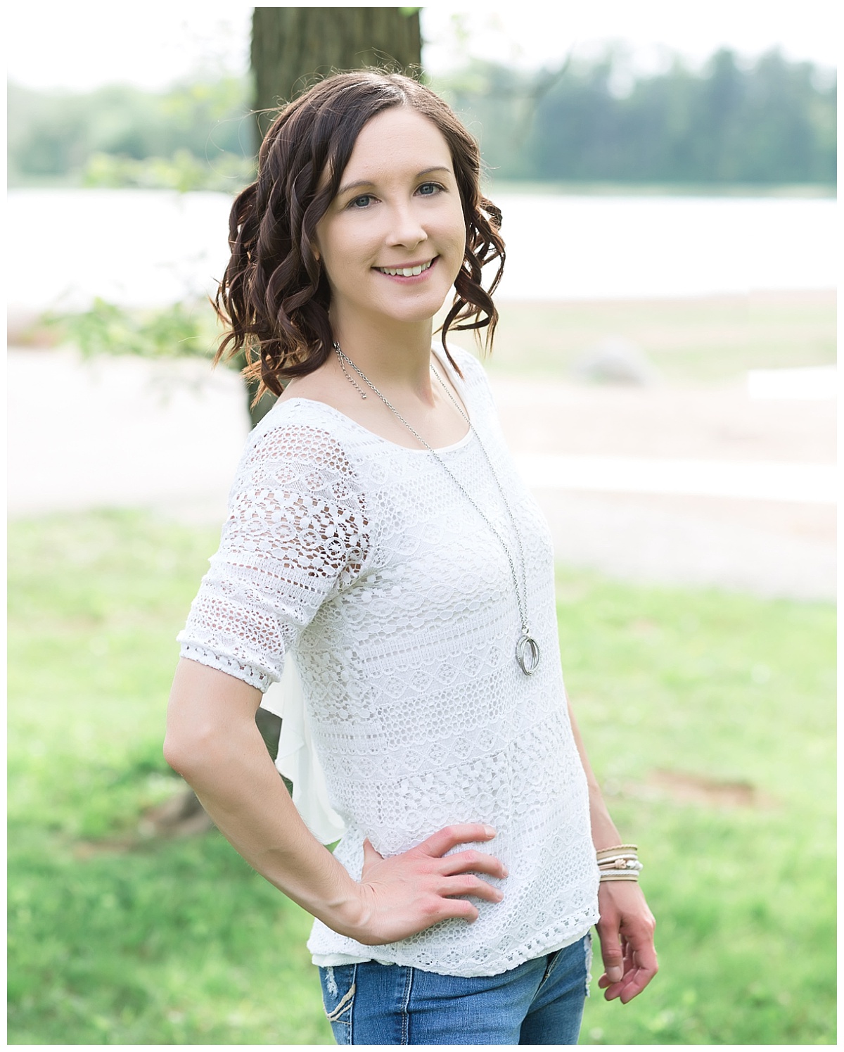young woman posing in grassy area