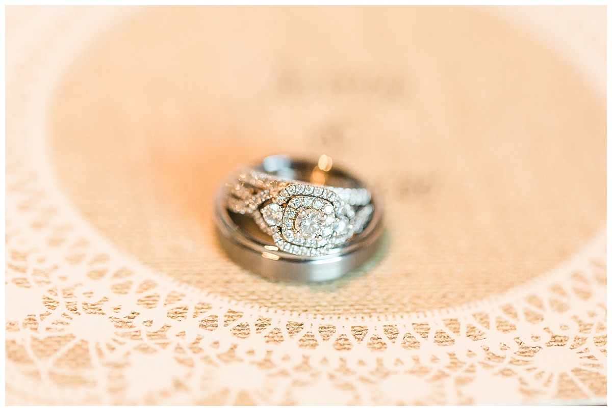 close-up of wedding rings on wedding invitation