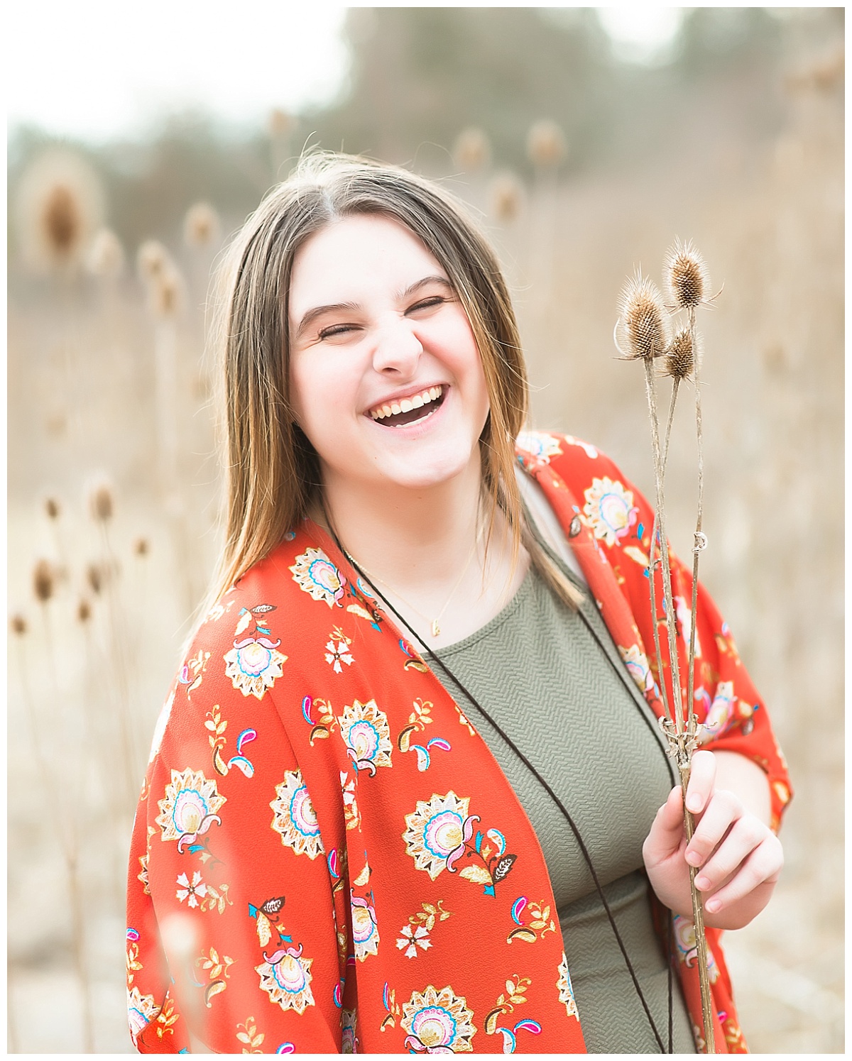 Senior girl in tall grasses photo by Simply Seeking Photography