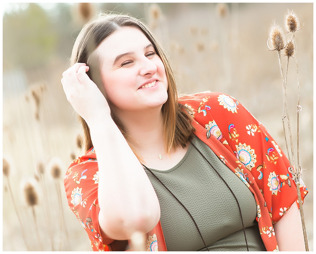 Senior girl in tall grasses photo by Simply Seeking Photography
