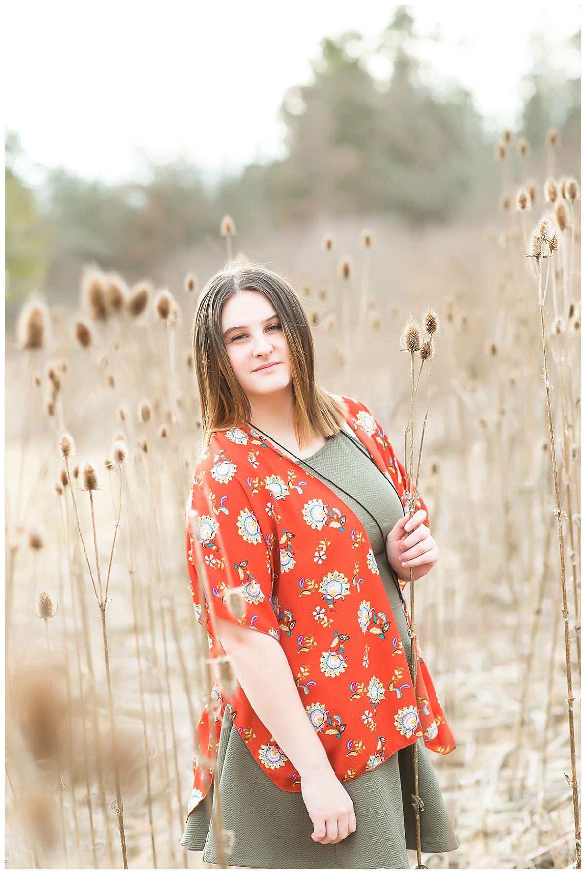 Senior girl in tall grasses photo by Simply Seeking Photography