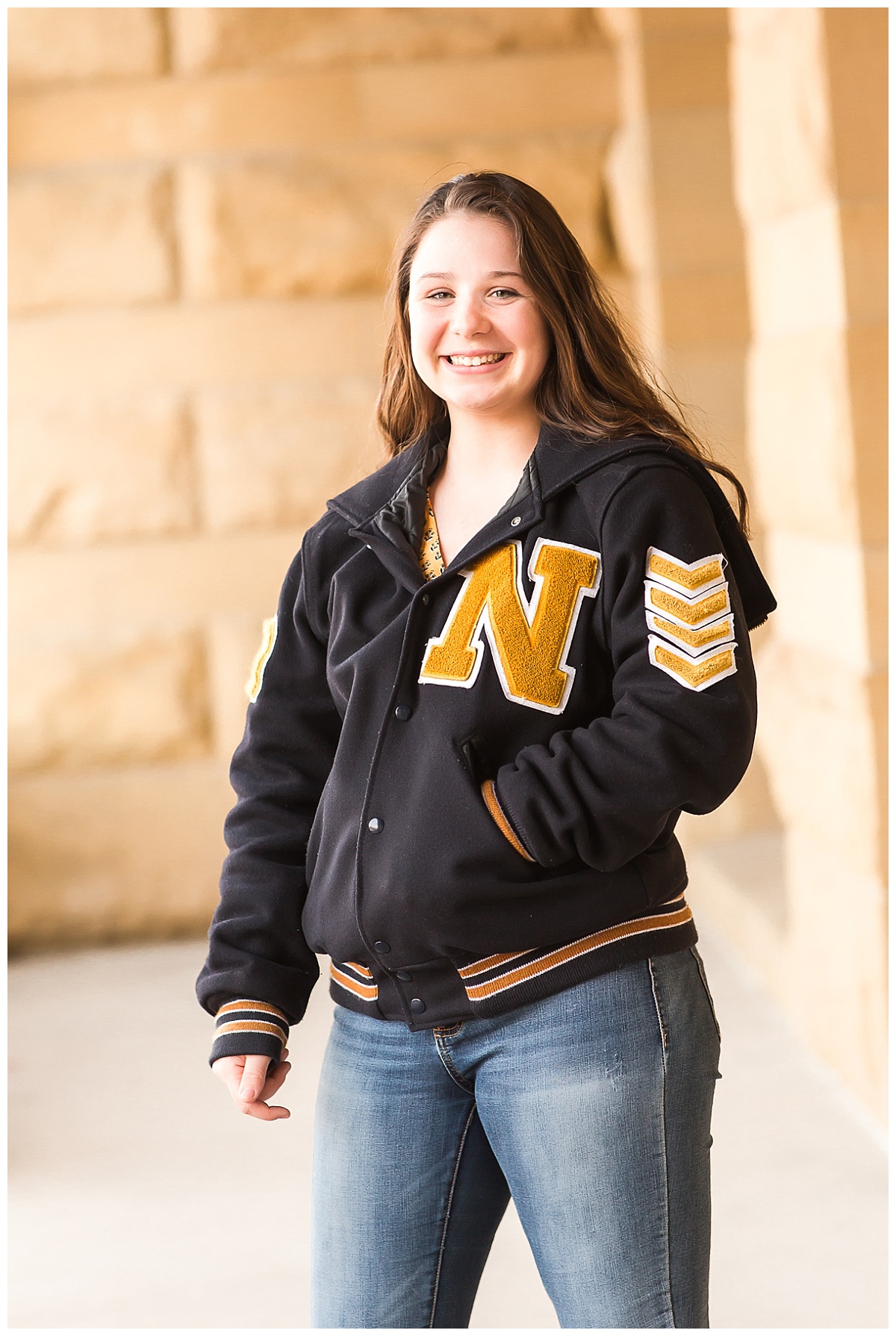 senior girl in letter jacket urban shoot