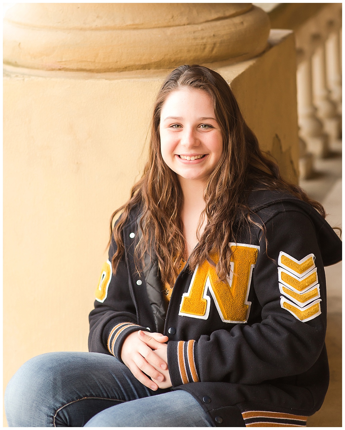senior girl in letter jacket urban shoot
