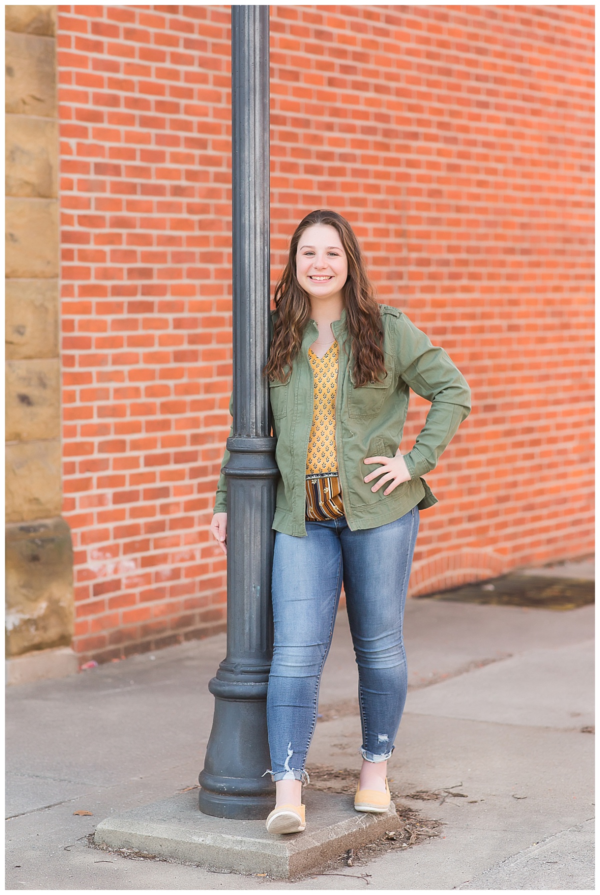 senior girl in front of brick wall