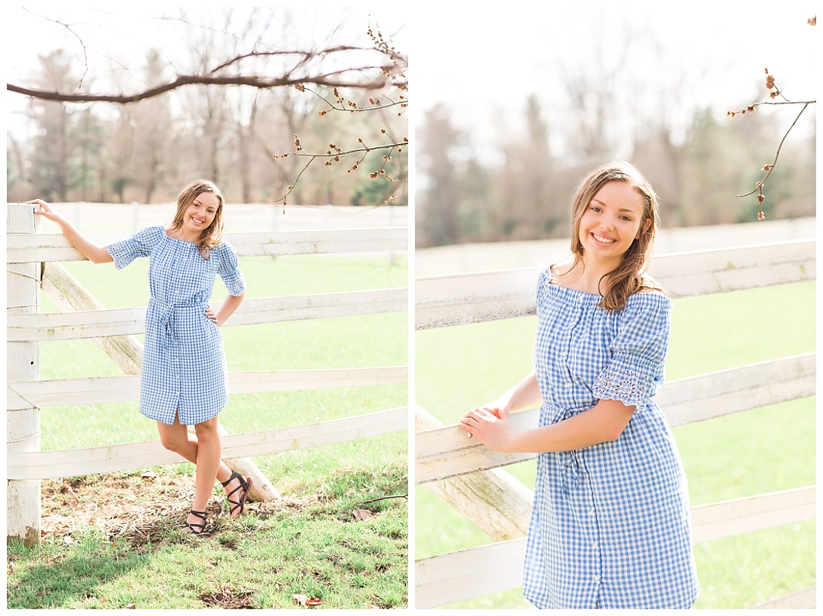 senior girl in front of white fence