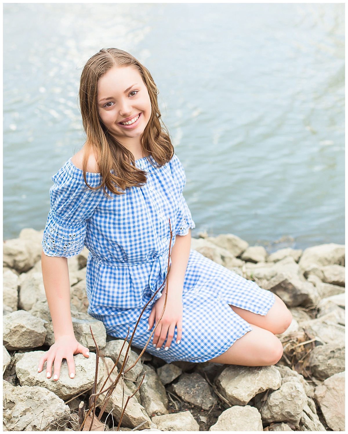 senior girl on rocks near river