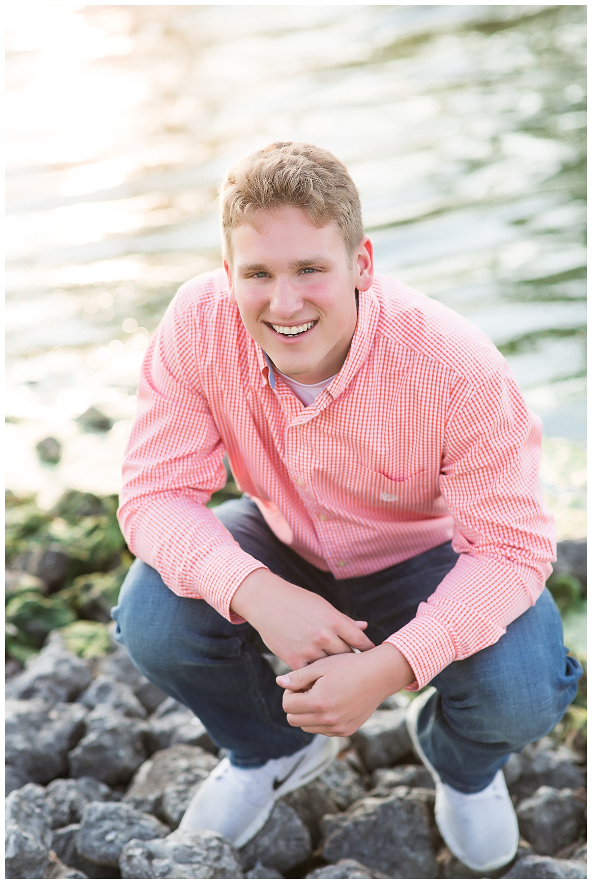 Senior guy squatting in front of lake photo by Simply Seeking Photography