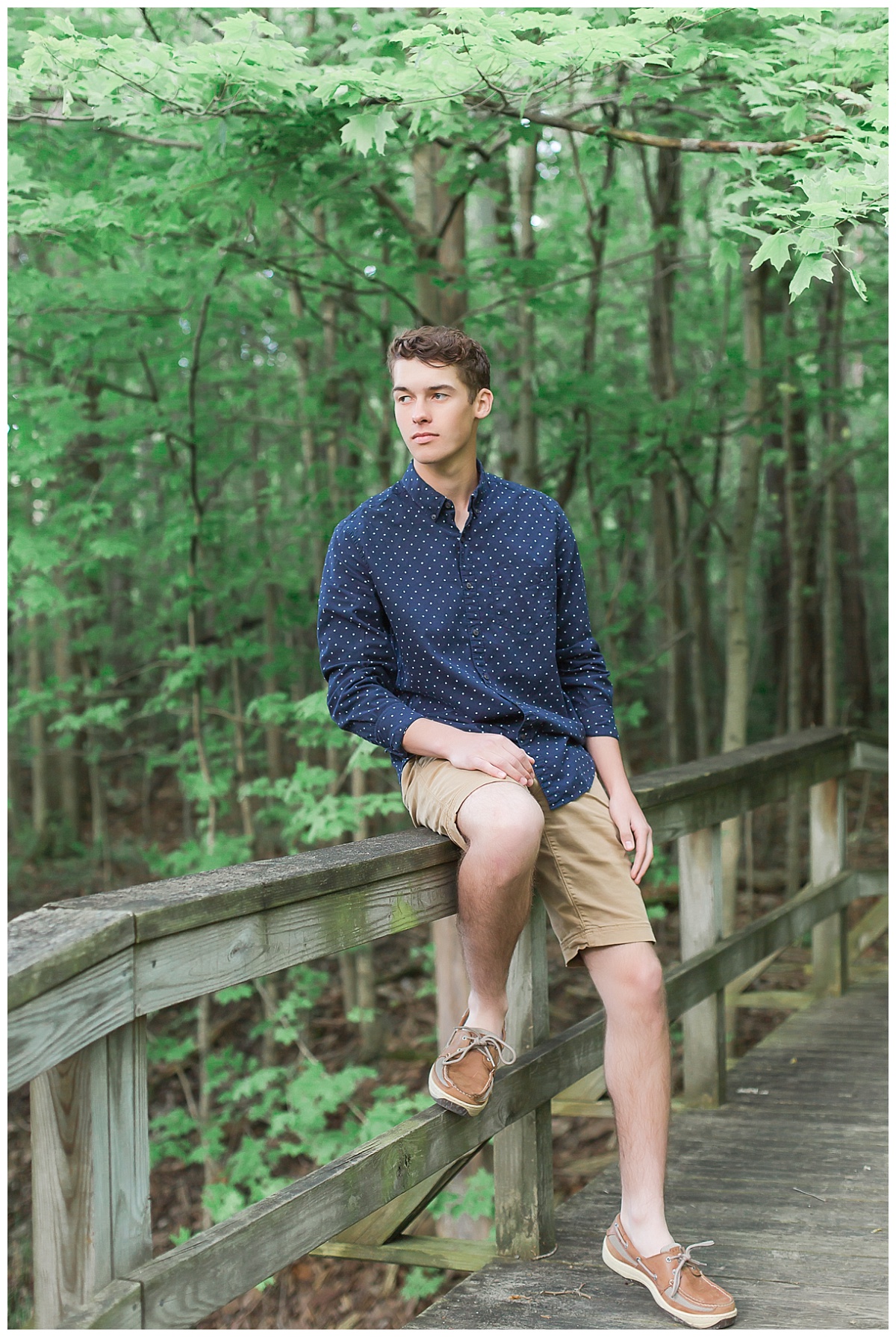 Senior guy by split rail fence in woods photo by Simply Seeking Photography