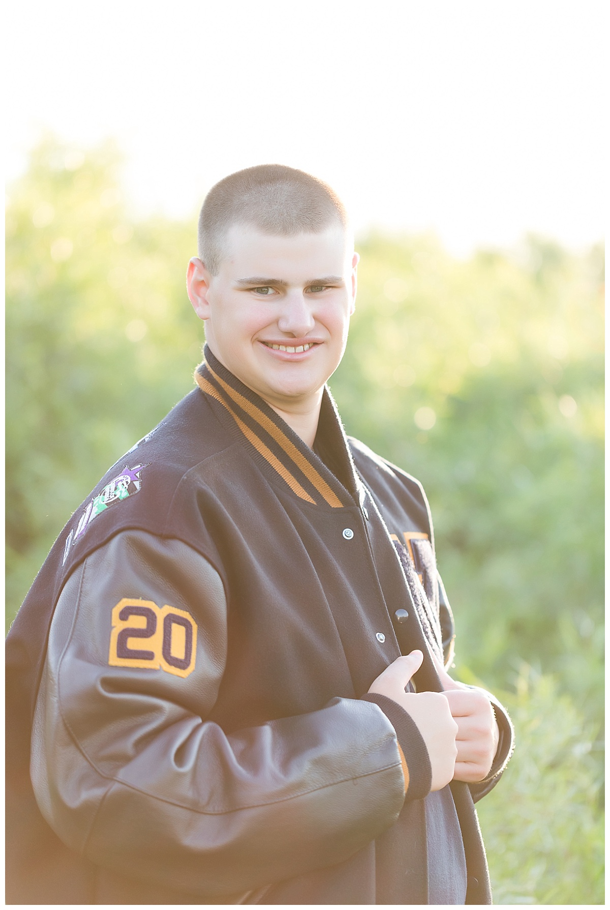 Senior guy in letter jacket photo by Simply Seeking Photography