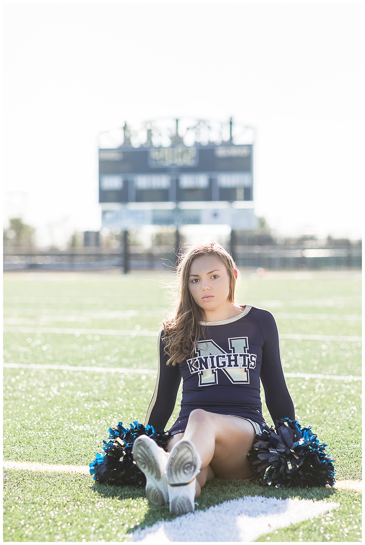 Senior cheerleader on football field photo by Simply Seeking Photography