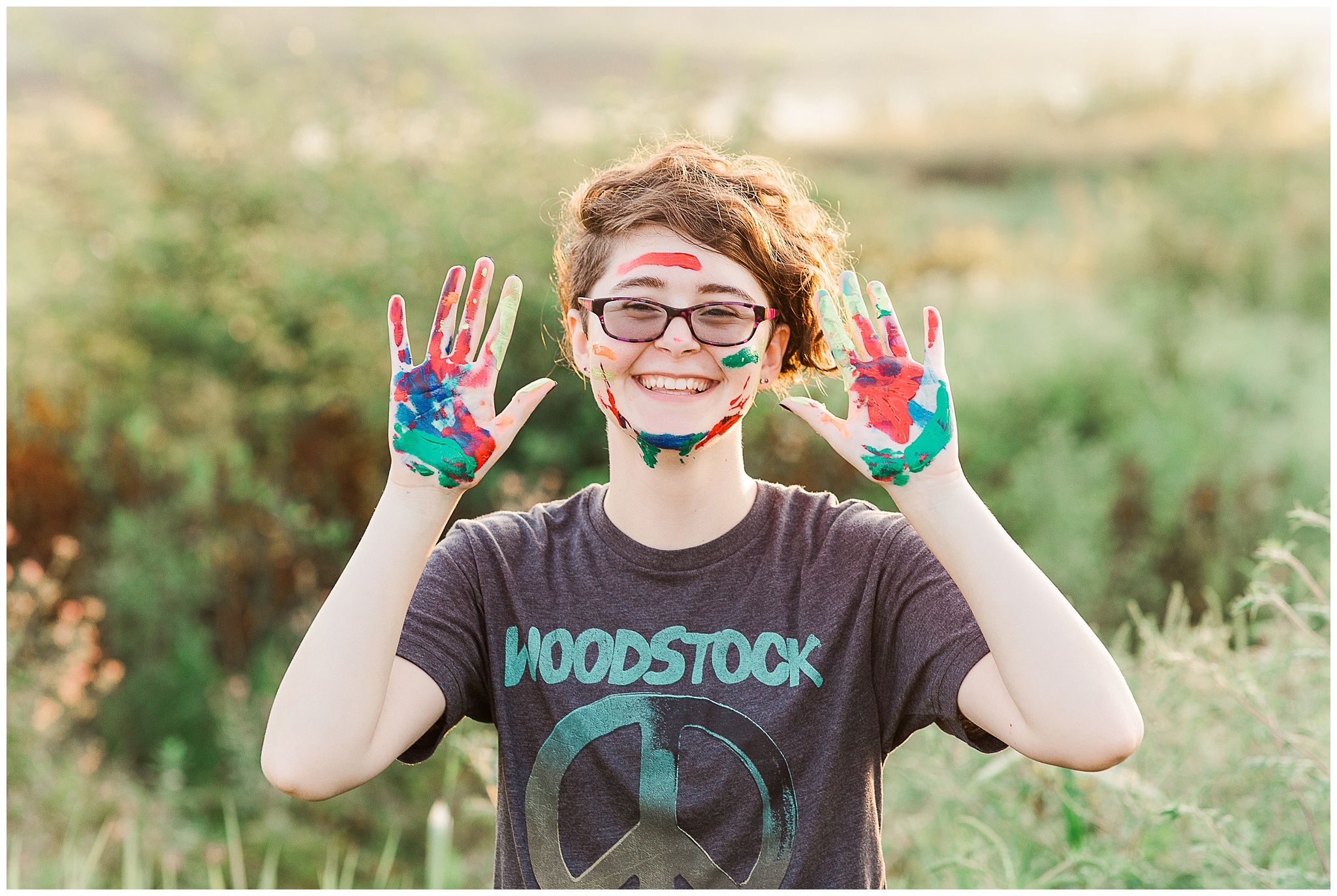 artist senior session girl with painted hands and face