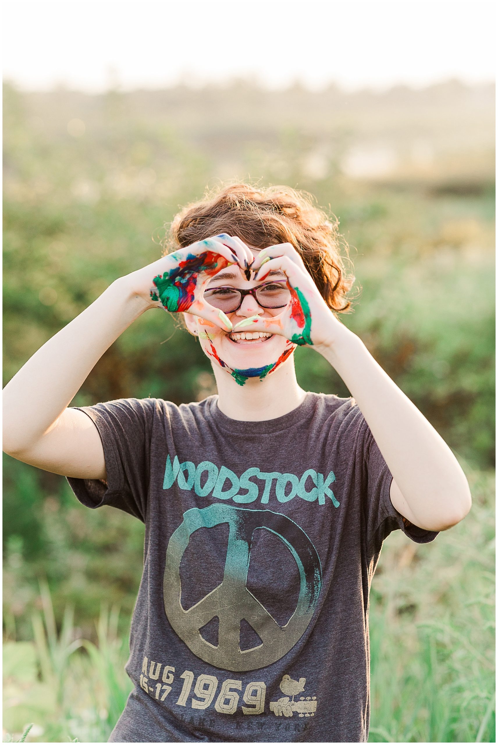 artist senior with painted hands and face