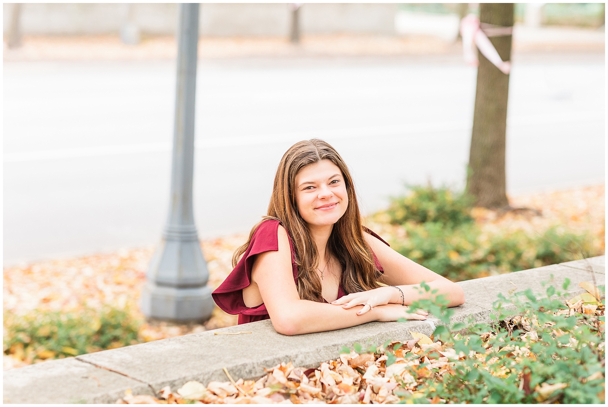 senior girl at Headwaters Park downtown Fort Wayne with fall foilage