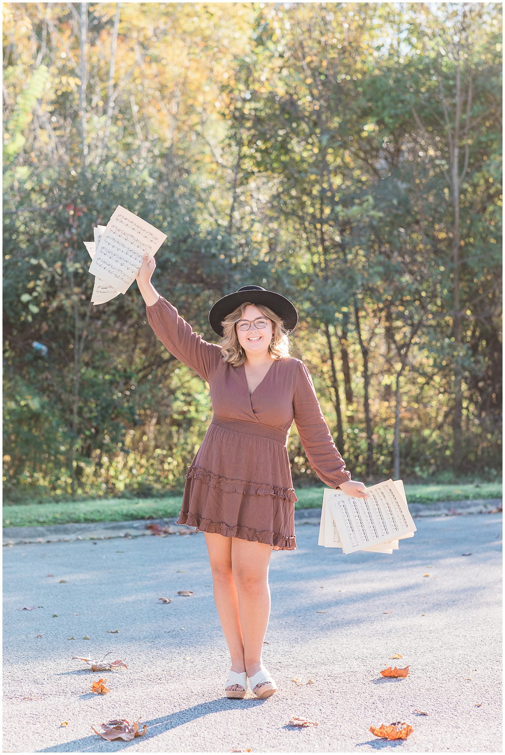 senior girl tossing music at boho senior session