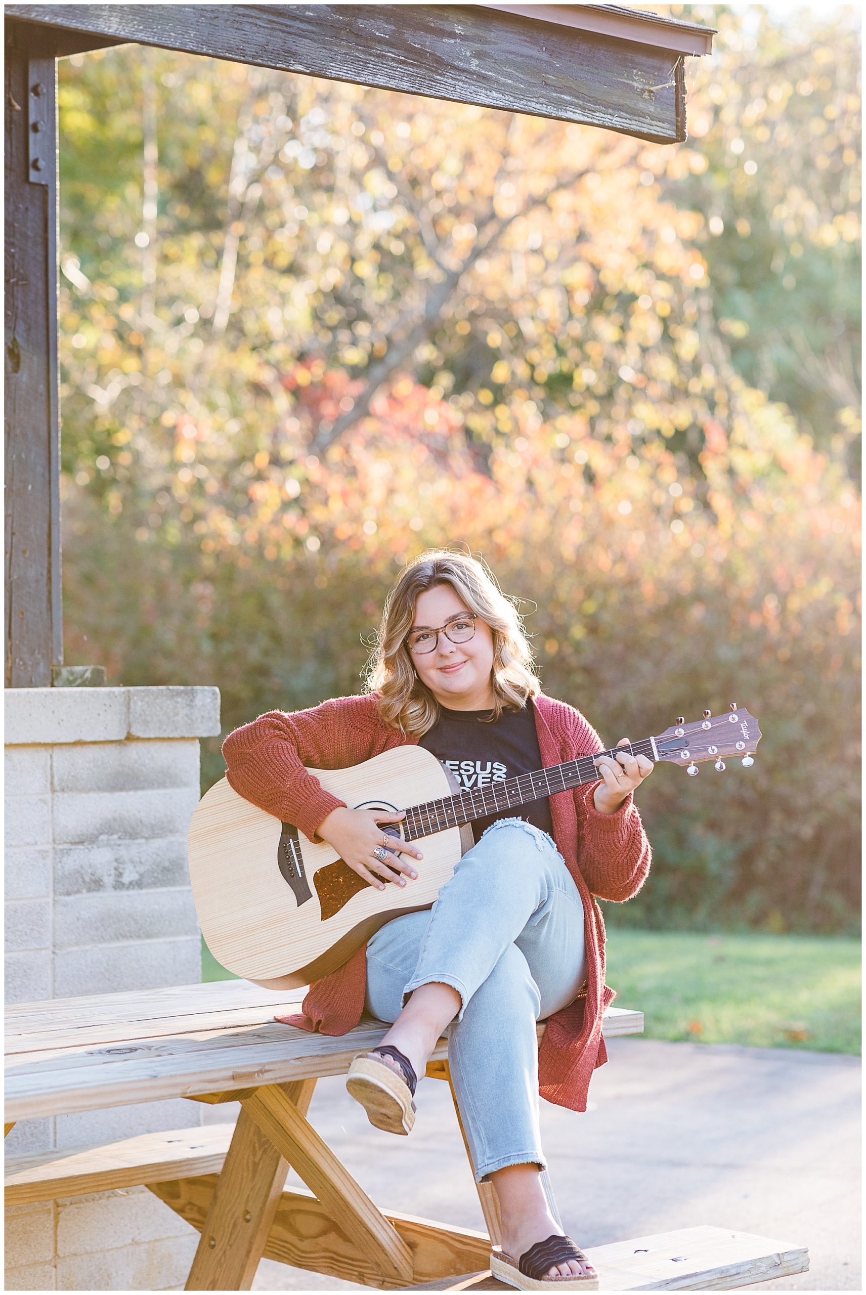 senior girl playing guitar at boho senior session