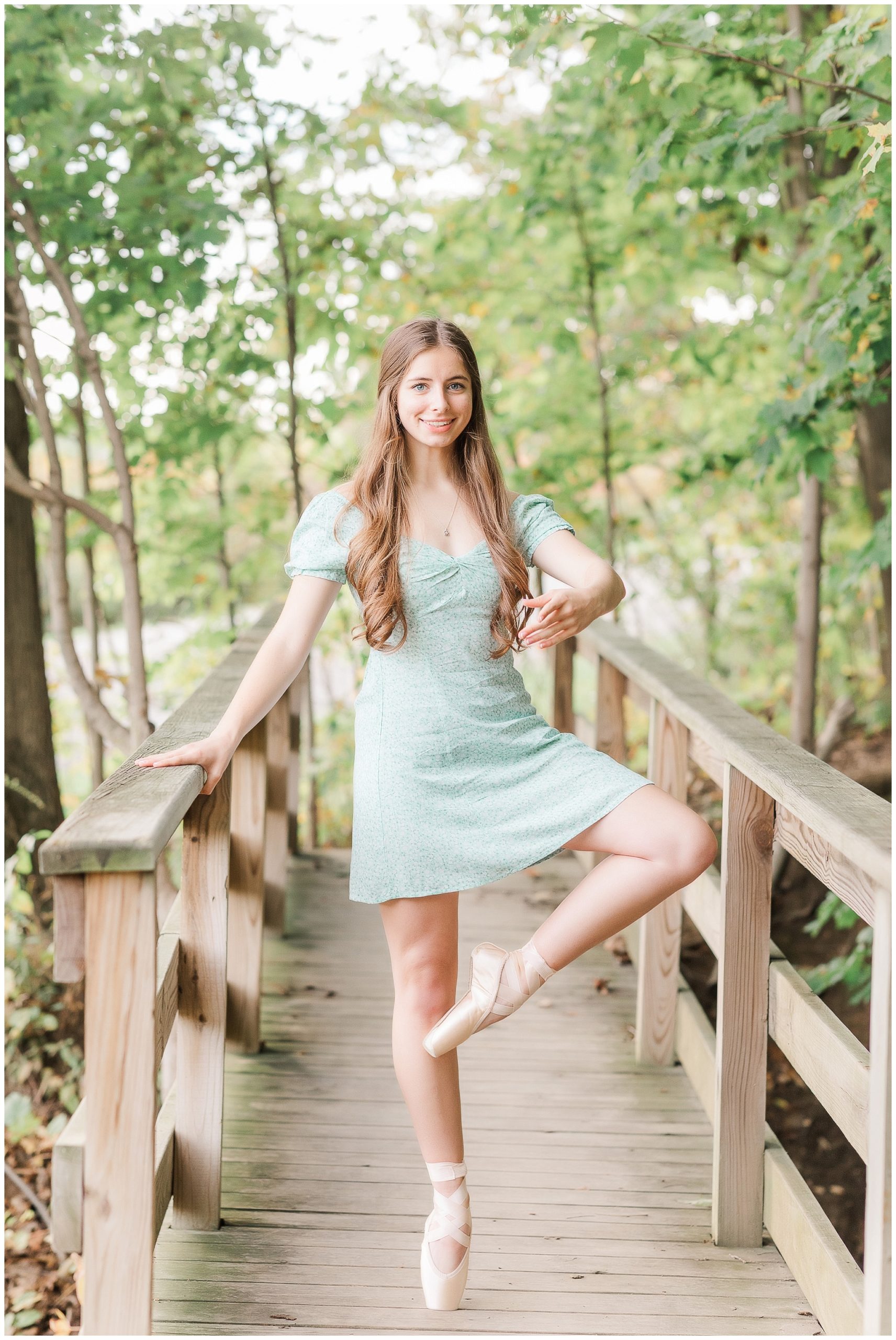 Senior girl in ballet pointe shoes on bridge at Metea Park Fall Senior Session